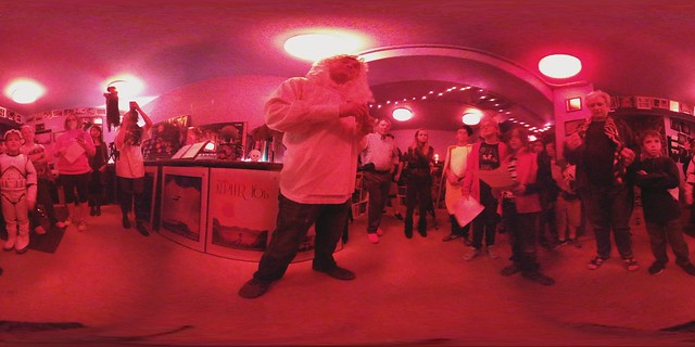 People standing in a room lit with red light