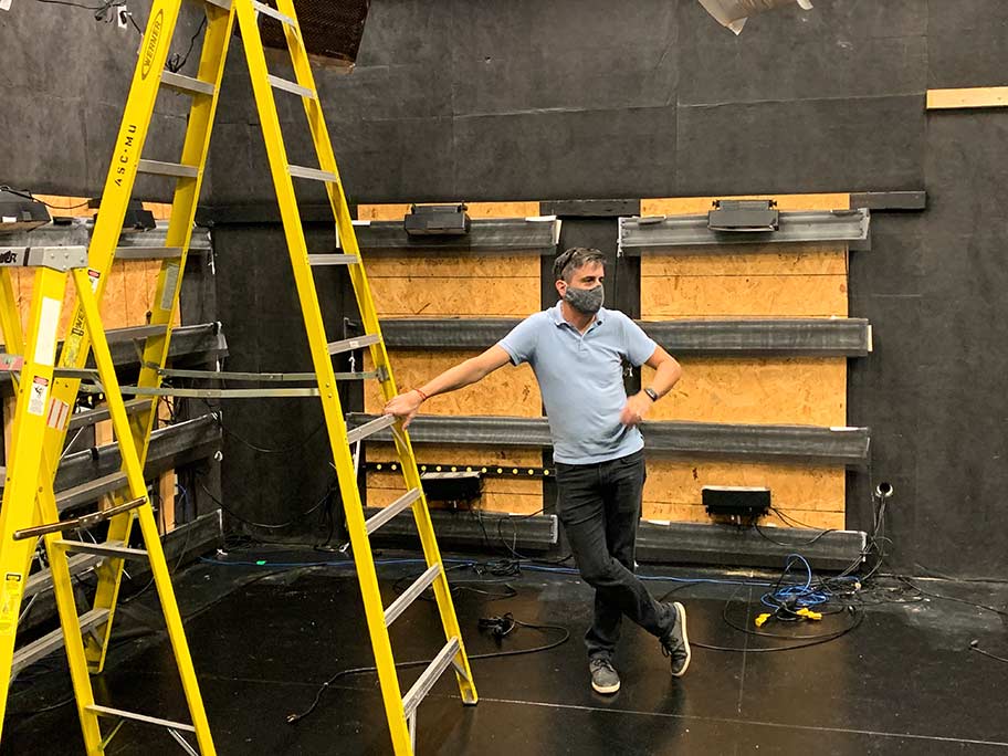 Senior Media Producer Travis McMillen surveys the construction of the new set in the studio at RJI | Click to enlarge