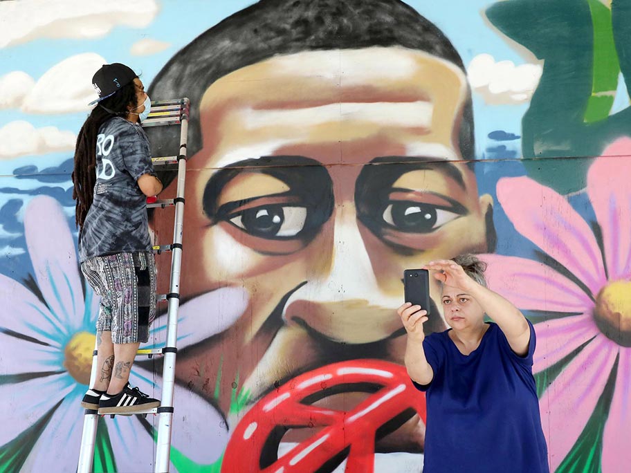 In this photo from June 2020, Lincoln Rust, left, and Anthony Catteruccia (not shown) made this mural on the Wisconsin Veterans Museum following the George Floyd protests. | Photo: John Hart, State Journal