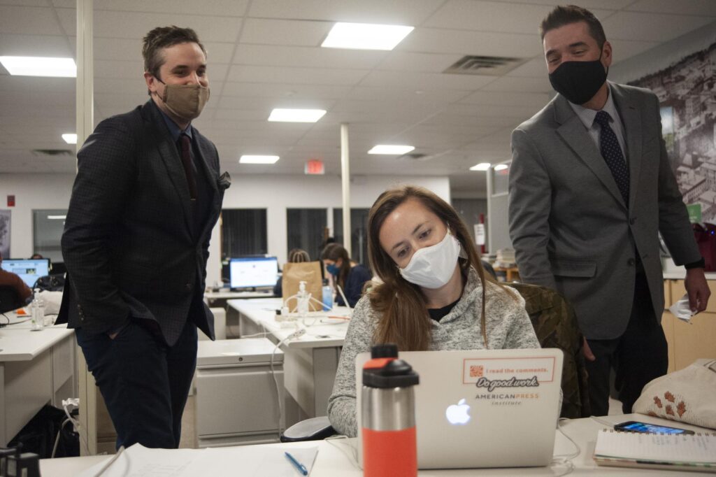 From left: BDN managing editor Dan MacLeod, News Editor Lindsay Putnam, and Technical Project Manager Deke Rhinehart monitoring returns on election night 2020. | Photo by Natalie Williams, Bangor Daily News