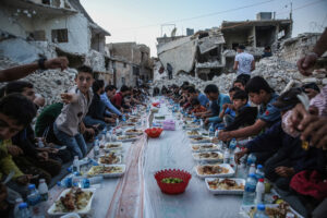 Residents of a Syrian destroyed neighborhood have an Iftar (breaking fast) meal together in Al Atarib town, during the Muslim's holy fasting month of Ramadan. A group of volunteers prepared a mass Iftar for the displaced residents of a neighborhood that was completely destroyed during the military operations in the countryside of Aleppo province.