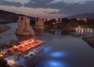 A view of ancient Hasankeyf is about to be flooded with its history which goes back approximately 12,000 years ago. With the completion of the Ilõsu Dam, the evidence of many existed civilizations along with their historical ruins will be vanished. The photo was taken on Sep. 15, 2019 My project tells the story about people from the Hasankeyf where is one of the oldest inhabited places in the world, who had to leave their ancient villages left underwater. Hasankeyf is located in the area of Mesopotamia that is also known as the Cradle of Civilizations, where both eastern and western civilizations have lived for over 12,000 years. The Ilõsu Dam and the hydroelectric power plant (HPP) project construction began in 2006 and was completed in 2019. In June 2019 the floodgates were closed in order to keep water inside. The Ilõsu dam project, along with other dams built in this region, is a reflection of the state's water policies. For this reason, as an open-air museum with many layers of time, Hasankeyf meets most of the required criteria to merit UNESCO's World Heritage status, yet it has not been submitted nomination proposals by the state. The Tigris Valley is in the ancient silk road, an area of approximately 100 km was buried underwater. 12,000 years of HasankeyfÕs history, hundreds of endemic species, and approximately 300 archaeological sites were affected by the dam's water retention, furthermore, around 100,000 people were forced to migrate. Regarding the Ilõsu Project, a total of 199 villages of Batman, Siirt, Diyarbakir, Mardin, Sirnak, and Hasankeyf, were completely submerged. Most of the population of these villages are of Kurdish and Arab origin. These people had to gain new experiences that they have never had before to overcome these extraordinary circumstances. For instance, a woman carried her husband's grave while another eighty-year-old woman got on the boat for the first time in her life, both had to make an effort to adapt to the fact that the whole process brought to their lives. My project aims to emphasize the obliged migration of culture to different places with a burdened journey.