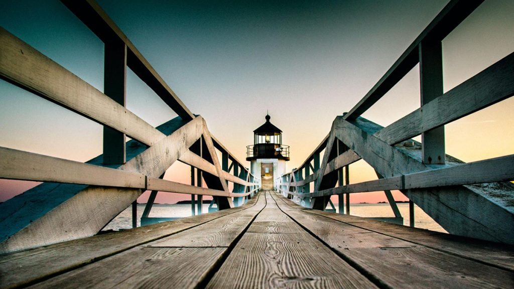 Lighthouse at the end of a pier. Photo: Donald Giannatti https://unsplash.com/@wizwow | Upsplash