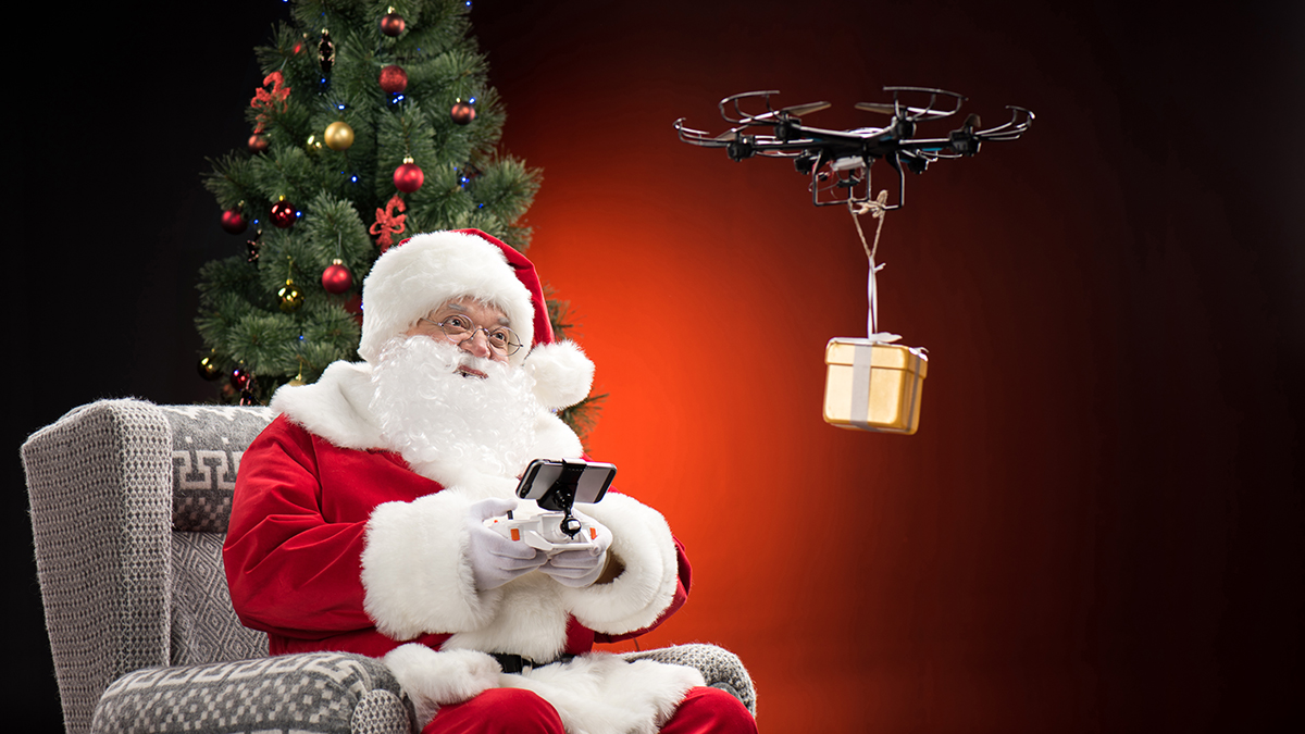 Santa Claus flying a gift with a drone