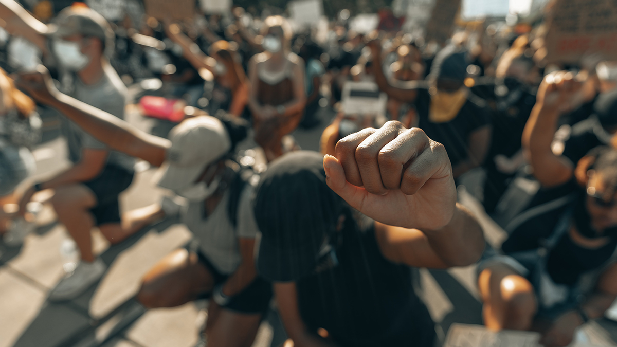 Crowd raising their fists in protest