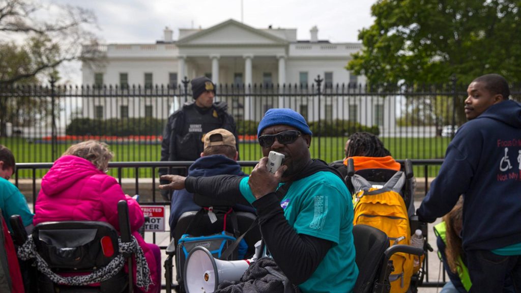 Demonstrators gather outside the White House in Washington, Monday, April 11, 2016, to urge President Barack Obama to support legislation to help disabled people who require long-term support stay in their homes. (AP Photo/Evan Vucci)