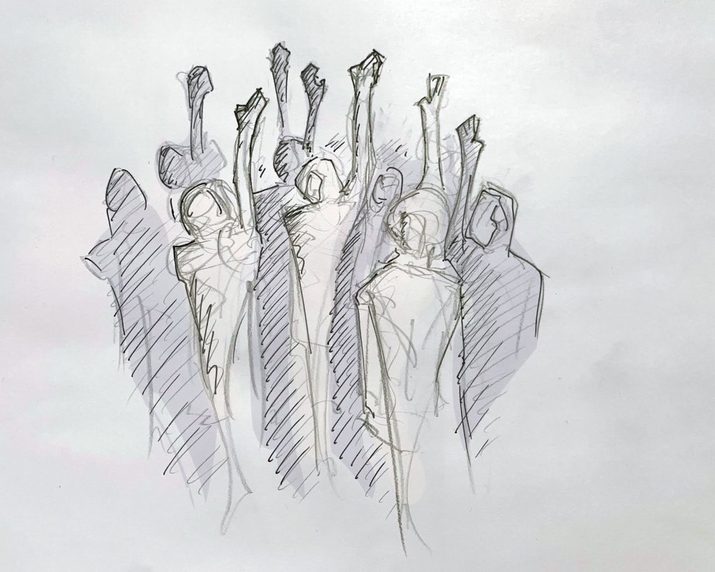 A group of people raising their hands while others stand silent