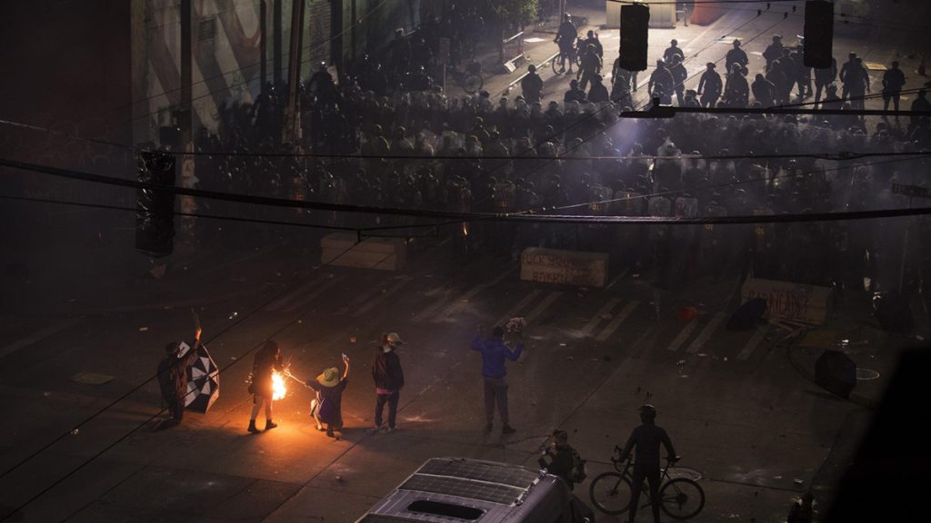 The exact moment that a flash bang grenade hit Aubreanna Inda, 26, on the 10th day of protests following the police murder of George Floyd, shortly after midnight on Monday, June 8, 2020, in Seattle. Inda was rushed to the hospital as medics and protesters performed CPR. Doctors would later tell Inda that she lost a pulse three times that night. Photo: Megan Farmer | KUOW Photo