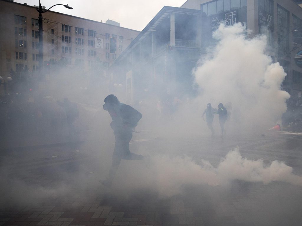 Protesters run from tear gas and flash bang grenades following the murder of George Floyd at the hands of police, on Saturday, May 30, 2020, at the intersection of 5th and Pine Streets in Seattle. Photo: Megan Farmer | KUOW Photo 