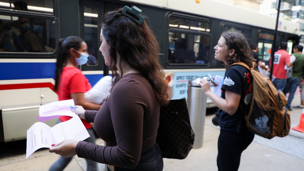 Borderless Magazine’s Engagement Reporter Diane Bou Khalil and Art Director Michelle Kanaar talk to migrants getting off buses at Chicago Union Station in September. Photo by Jesus J. Montero for Borderless Magazine