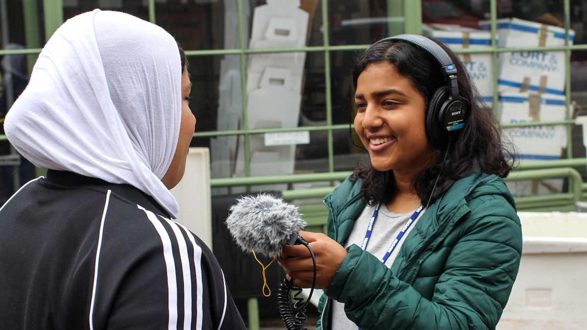 Ritika Managuli (right), a youth producer with RadioActive Youth Media at KUOW Public Radio, practices interviewing skills at Pike Place Market in Seattle, Washington on July 10, 2019. Credit: Kelsey Kupferer