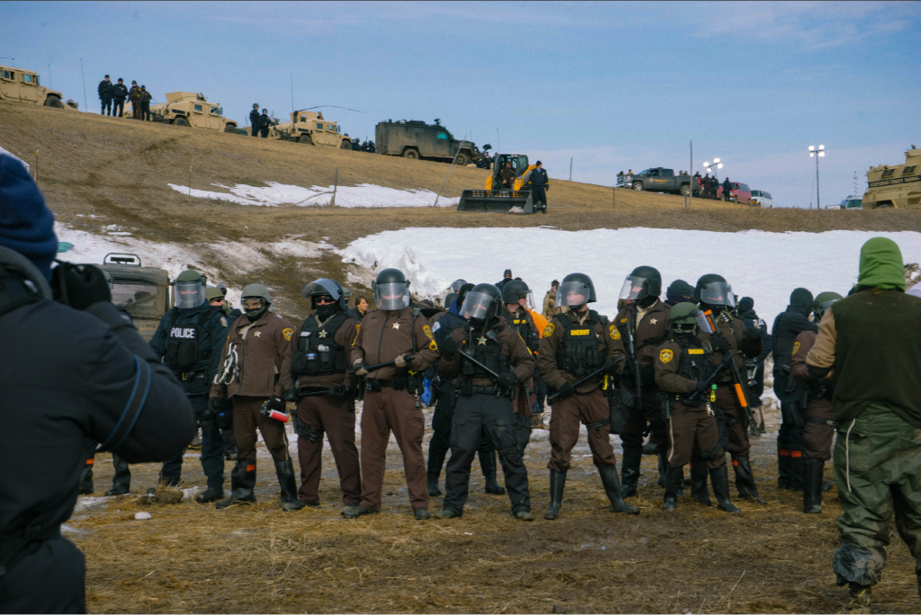 In February 2017 the Morton County Sheriff's Department cleared the Oceti Oyate Camp in Standing Rock, North Dakota. This police action was in response to elder Regina Brave’s treaty stand, which meant to assert the 1868 Treaty of Ft. Laramie, documenting Oceti Sakowin stewardship of the territory. Photo: Jen Byers