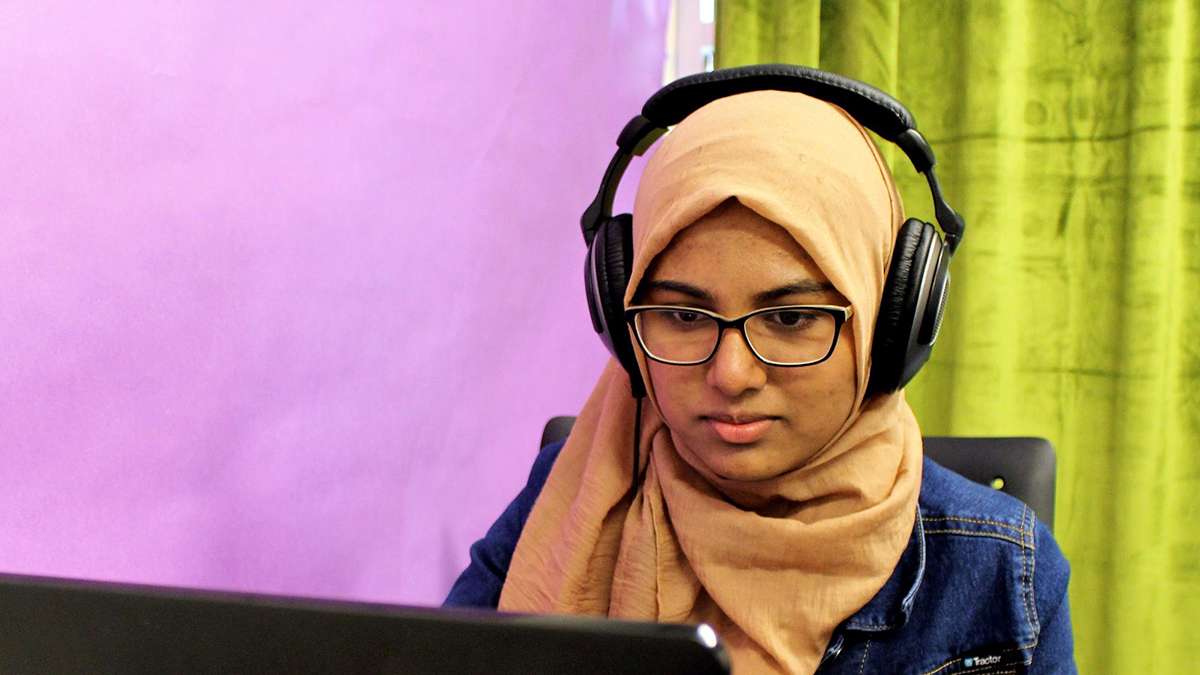 Youth producer Ayesha Mohammed edits audio in the RadioActive Youth Media studio at KUOW Public Radio in Seattle, Washington in August 2019. Photo: Kelsey Kupferer