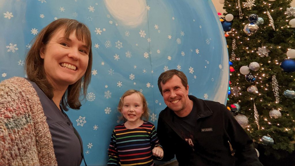 This is me with my husband Ben Decker and our kid Jude on December 10, 2022, when we were all healthy enough to see a holiday show in St. Cloud, MN.