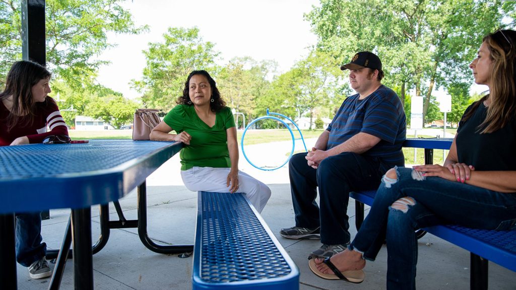 Current and former West Chicago residents Erika Bartlett, Julieta Alcantar-Garcia, Mike Merrion, and Ester Escamilla Hughes talk about the effects of thorium contamination on their lives at Pioneer Park in West Chicago, Ill., Sunday, June 5, 2022. Photo: Jonathan Aguilar | Borderless Magazine