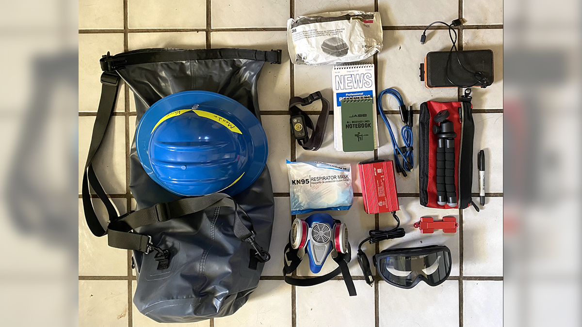 Some (but not all) of the items in my reporter bag, including mobile reporting equipment, back-up batteries, and some safety equipment.