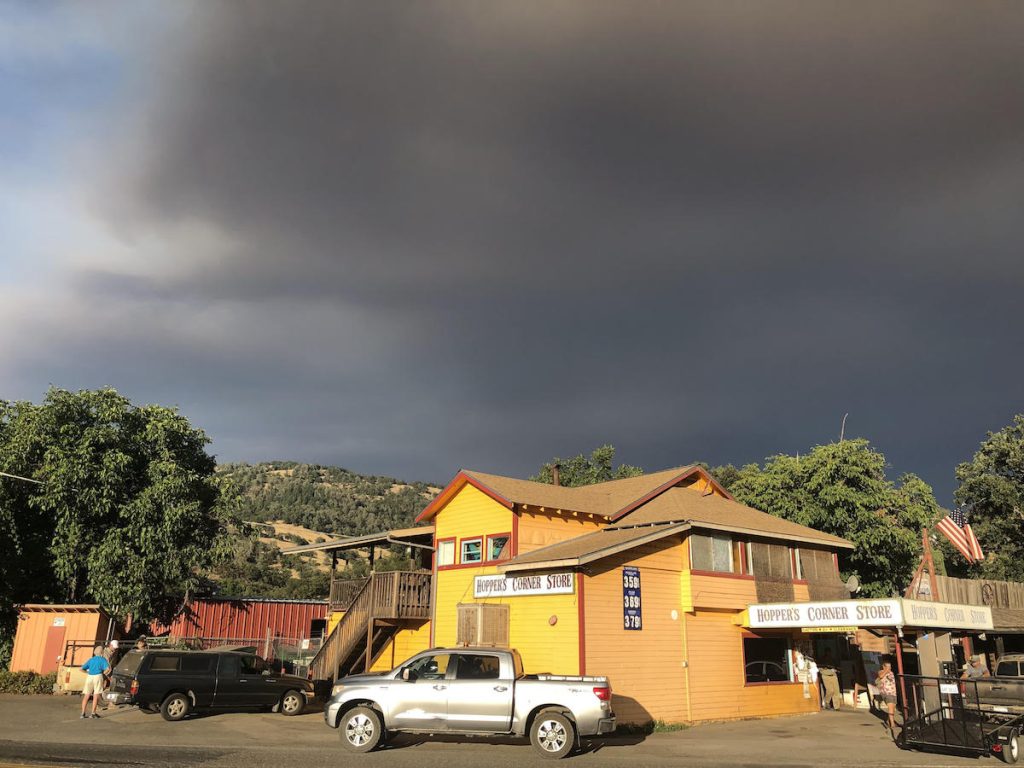 Smoke from the Ranch Fire in the sky behind Hopper's Market in Potter Valley, CA.  Photo: Kate Maxwell 
