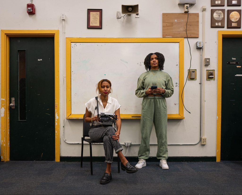 Photo of two women in front of a white board