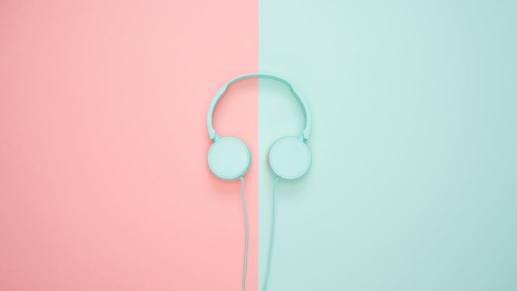 Green headphones on a background half pink and half green