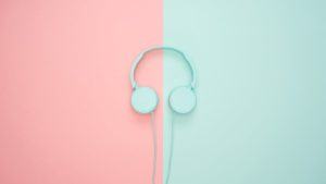 Green headphones on a background half pink and half green