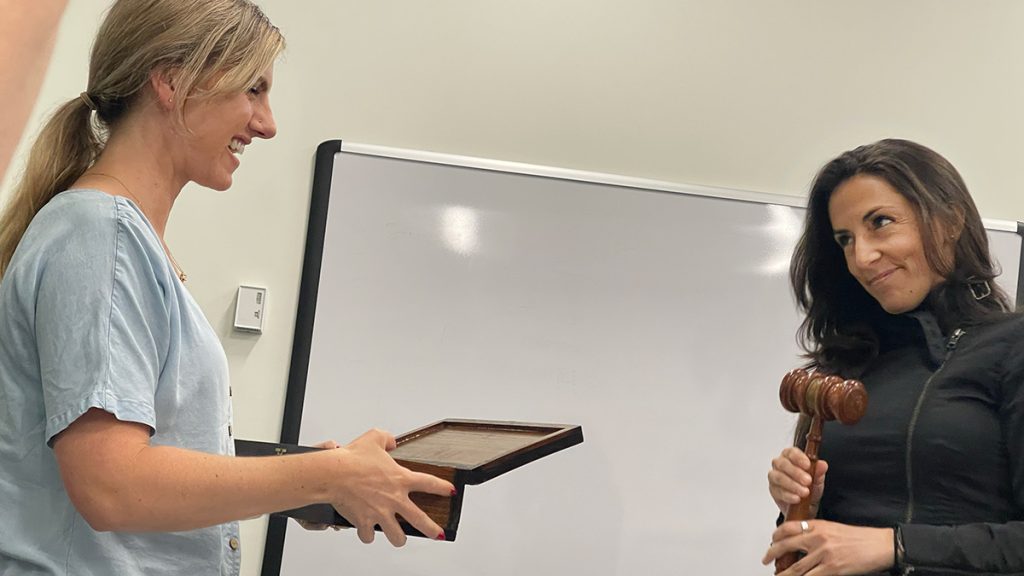 NPPA Immediate Past President Katie Tarasov (left) presents NPPA President Marie de Jesús (right) with a ceremonial gavel. From 2022 to 2024, Marie served as president. Previously she served as NPPA secretary and chair of the mentorship program. Photo: Alicia Calzada