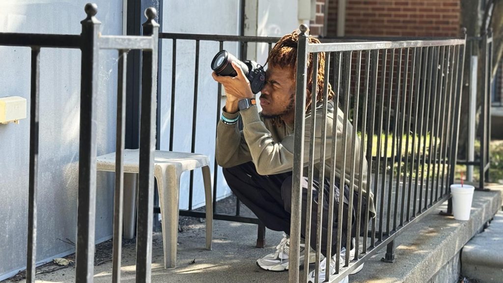 Jacob Wooten, Outlier Media's 2024 summer photojournalist intern, works on assignment at the Foundation First Childcare Development Center in Detroit on Wednesday, June 12, 2024. Wooten’s images illustrated a story about the high cost of child care in Detroit. Photo: Cydni Elledge | Outlier Media