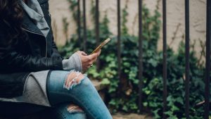 Woman sitting looking at her phone