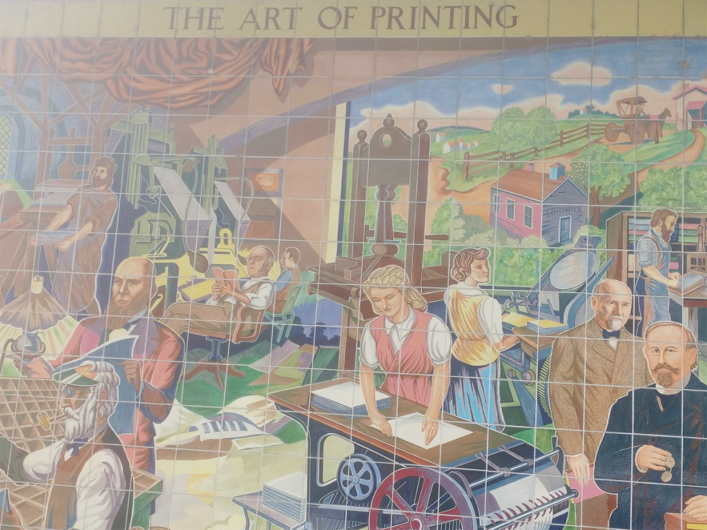 A mural on the exterior of the Southeast Missourian's 100-year-old office building, which is on the National Register of Historic Places. The mural depicts the history of printing in Cape Girardeau.