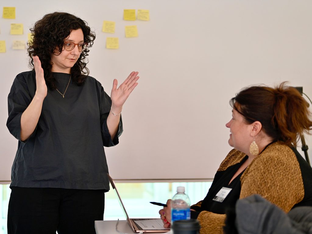 Jennifer Mizgata, left, visits with Kelly D. Hicks, director of newsroom training and development at Nexstar Media Group, during one of Friday morning's sessions. Mizgata, a 2023-24 RJI Fellow, spoke Thursday on "Building better work culture." Mizgata is the founder of Little Key and creator of Building News Culture training. 