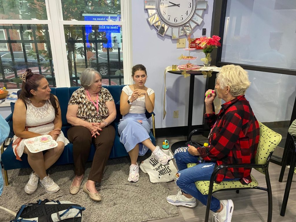 Cristal Sanchez, RJI Student Innovation Fellow, center, speaks with community members about Spotlight Delaware en Español at the local Latin American Community Center.