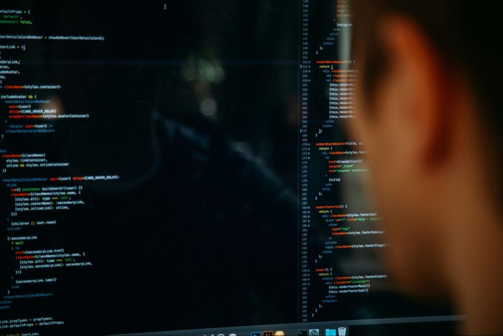 Man looking at code on a screen.