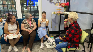 Cristal Sanchez, center, speaks with community members about Spotlight Delaware en Español at the local Latin American Community Center. Photo courtesy of the Latin American Community Center.