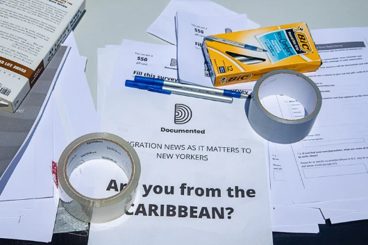 Photo of a desk full of office supplies and a questionaire