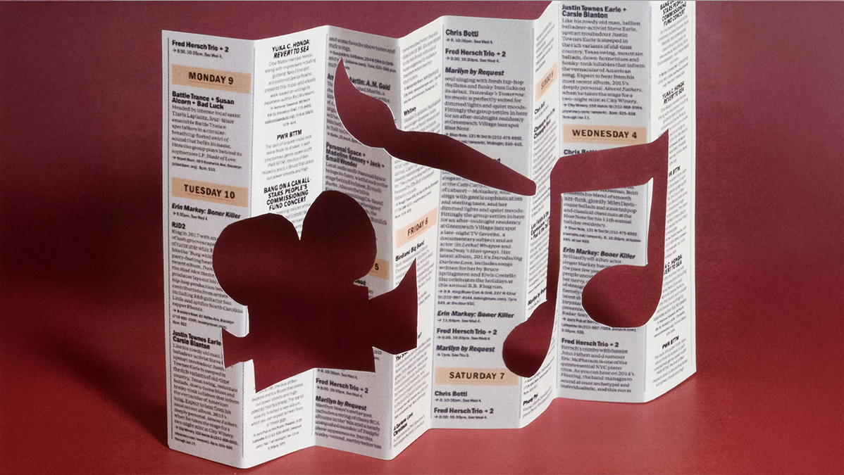A brochure standing up on a table with the images of a film camera, a paint brush and a musical note cut out of the paper. Image: Ben Denzer | The Atlantic