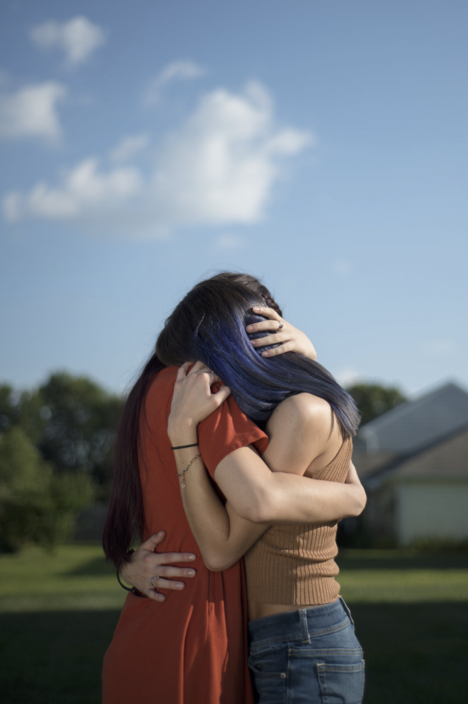 Two anonymous women embracing.
