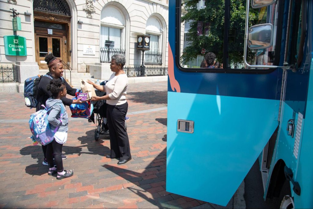 Gigi, a member of Mobile Health Map’s interdisciplinary healthcare team, speaks and shares resources with clients outside of MHM’s mobile van that is specially equipped with healthcare  resources.