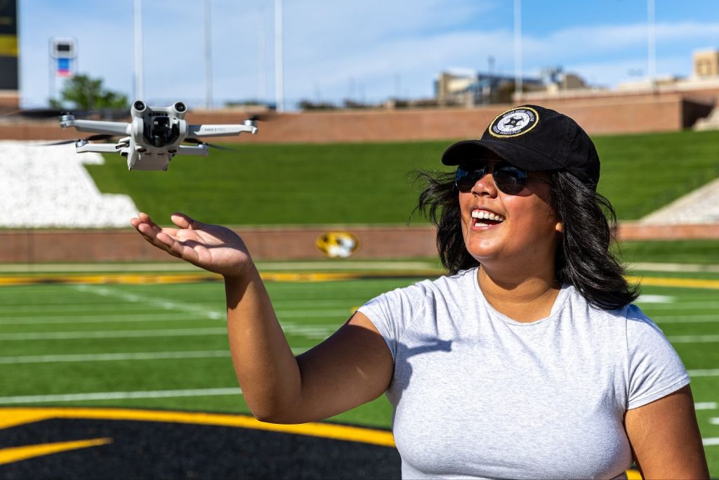 Cam Medrano is a Part 107 certified student who earned the Top Drone title in 2024 and secured a reimbursement for her commercial exam for her excellence in academics and flight performance. She holds the record highest grade percentage in the class at 99%