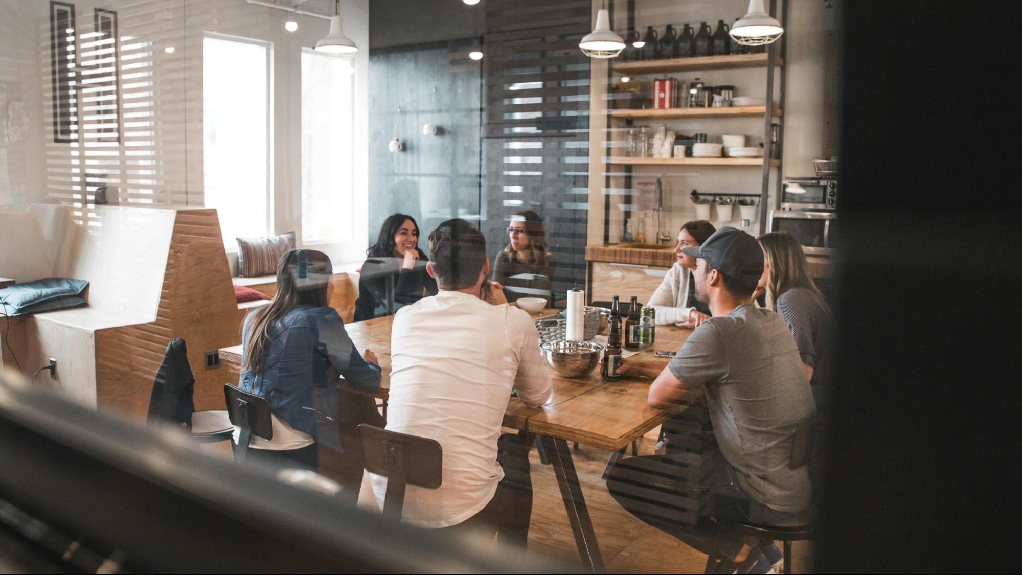 People gathered around a table talking