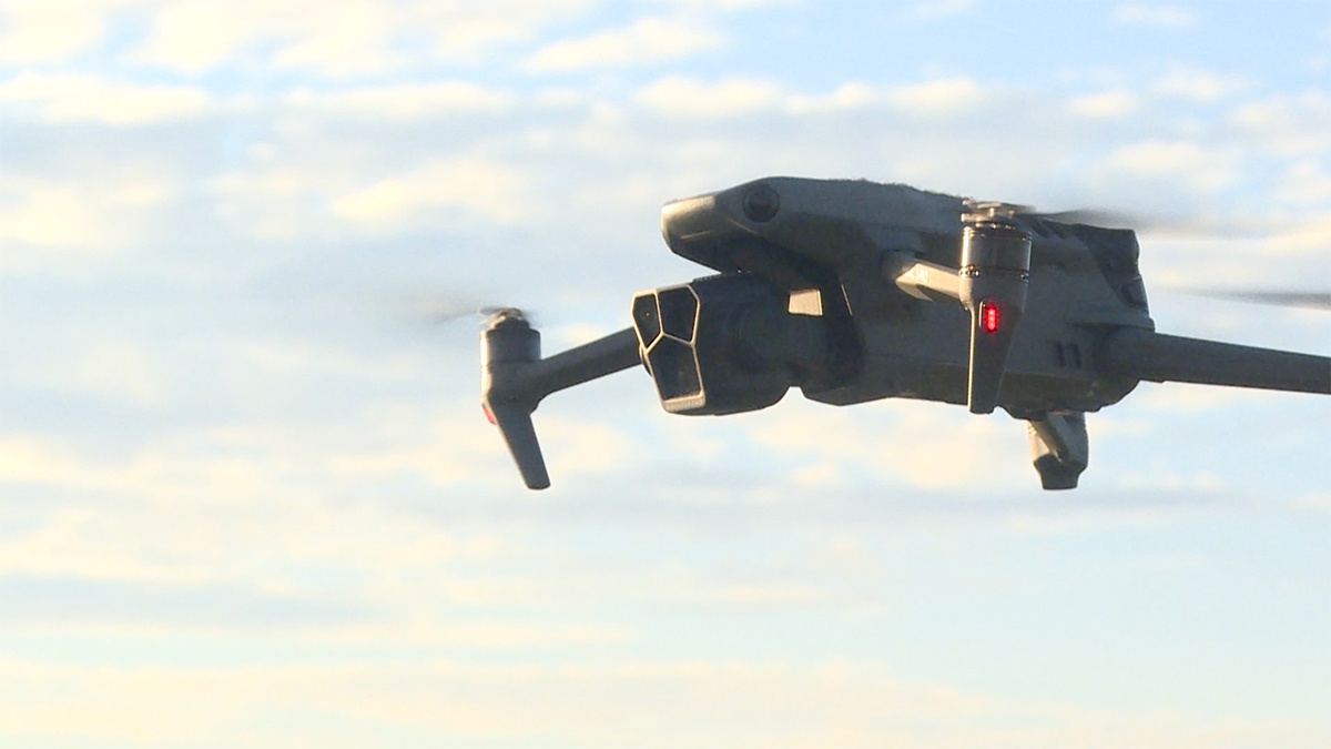 Drone flying against a cloudy blue sky