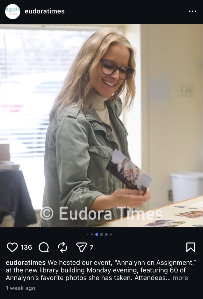 Eudora Times shared images from the event on their Instagram page, including this photo of an attendee admiring the postcards.