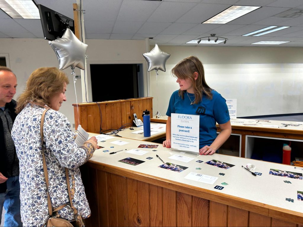 Annie Goodykoontz, RJI Innovation Student Staffer, talking to attendees about the postcard project.