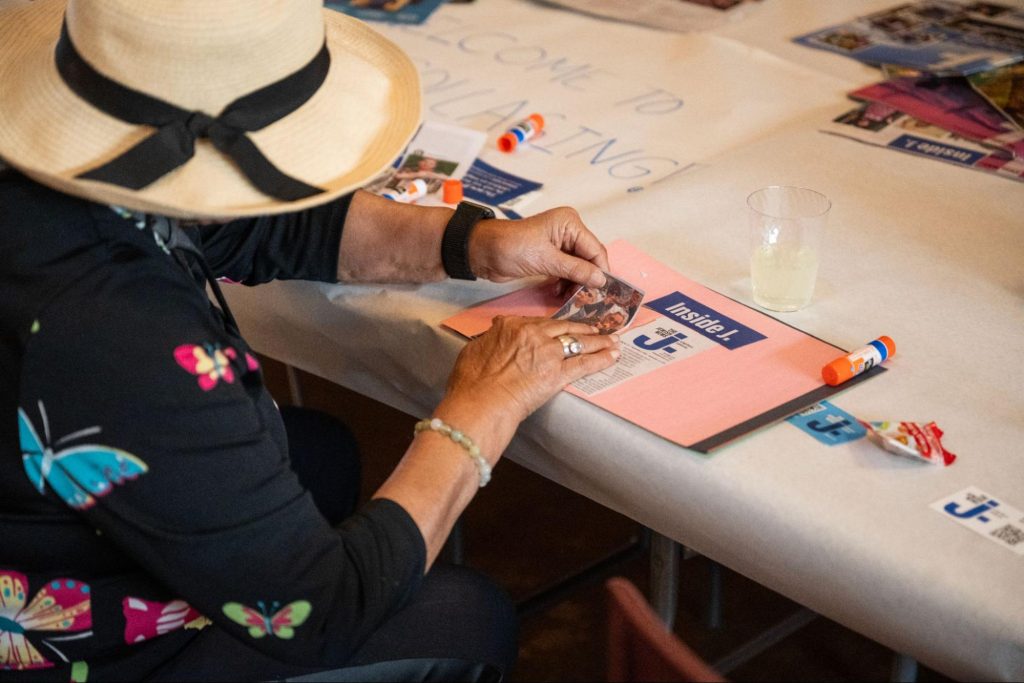 Woman in a hat scrapbooking.