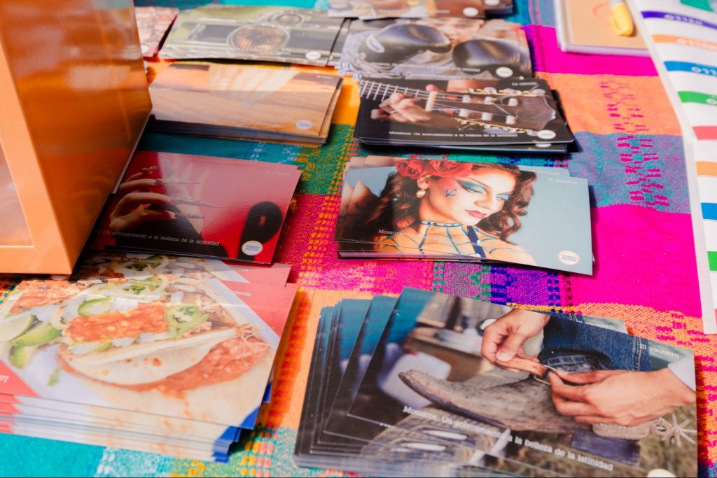Stacks of colorful postcards on a colorful table cloth