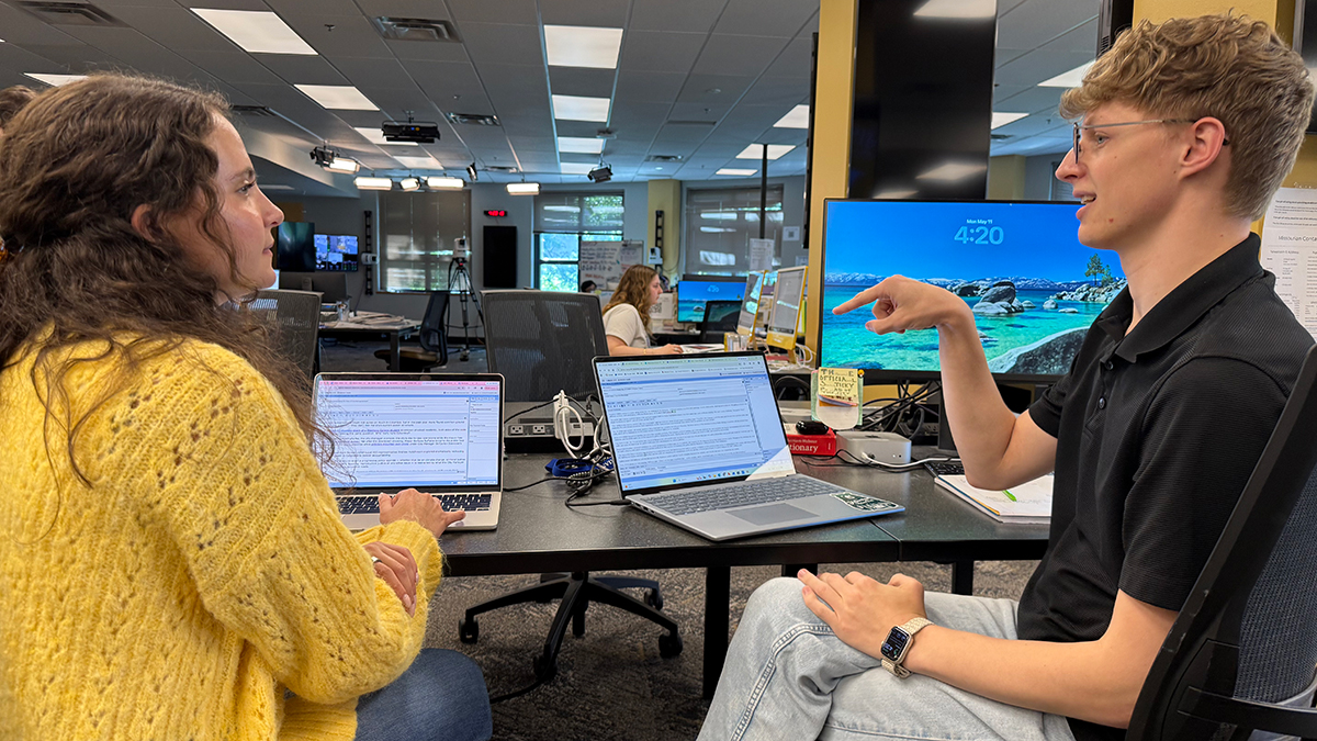 After participating in the research as assistant city editors at the Columbia Missourian, Amber Roldan, left, and Max Quinn, right, use tutoring techniques when editing each other's copy.